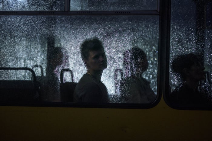 A passenger looks out of a city bus window during a rain shower in Dnipro on Monday evening.