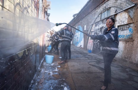 Kemi Badenoch cleaning graffiti off a wall in Herne Hill, south London. She is saying that, under the Tories, vandals would be forced to clean up graffiti they cause immediately.