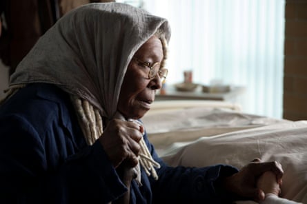 Woman wearing headscarf and glasses.