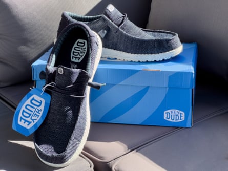 HeyDude Wally slip-on shoes next to box on couch