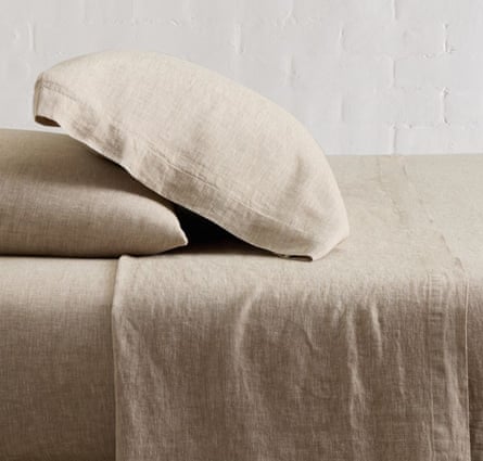 an oatmeal colored sheet set on a bed