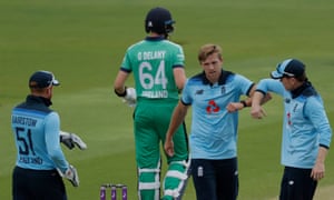 David Willey of England celebrates with captain Eoin Morgan after getting out Delany LBW.