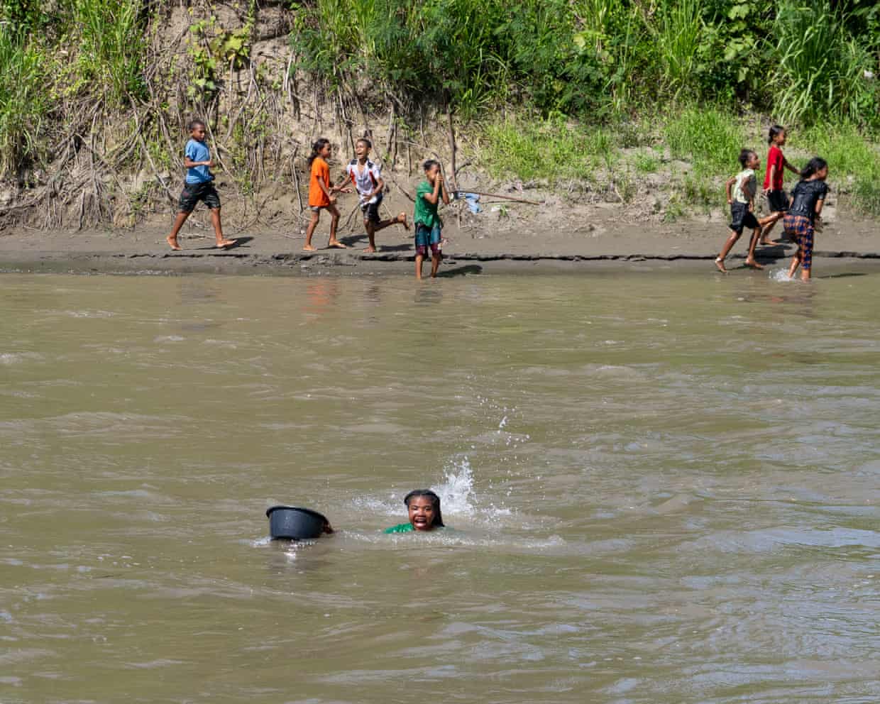 A teenage girl swims across a crocodile-filled river to reach a school