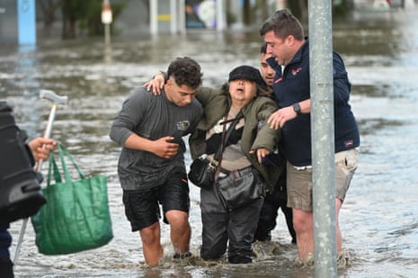 A woman is rescued from flood waters in Maribyrnong, Melbourne.