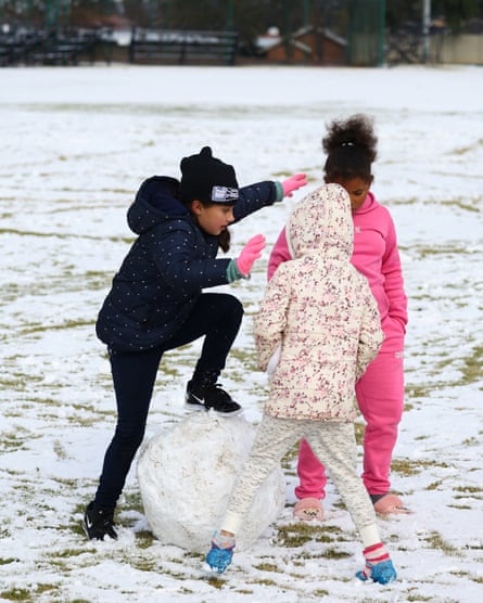 Children play in the snow at Laerskool Orion, a school located in Brackenhurst, a suburb south of Johannesburg in South Africa