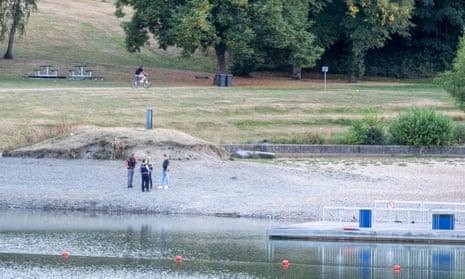 Police officers on the shore of the Eiserbachsee after two British children drowned on Thursday.
