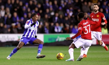 Kobbie Mainoo competes for ball