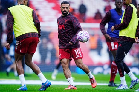 Liverpool’s players warm up with a game of Mo-in-the-middle.