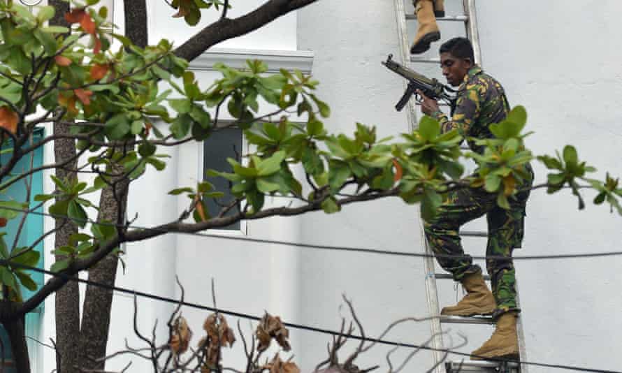 Sri Lankan special forces climb a ladder during a raid at an address in Colombo.