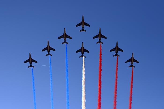 Patrouille de France flies over the Champs Elysees in Paris.