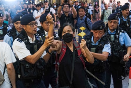 Chan Po-ying, an activist and leader of League of Social Democrats, is detained by police officers at Causeway Bay near Victoria Park in June 2023.