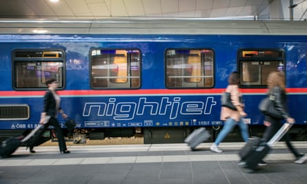 Nightjet sleeper train in a station, in Austria, as travellers get ready to board it.
