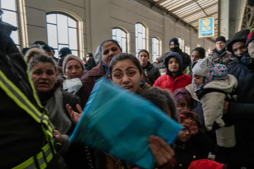 Refugees struggle to get on to the evacuation train from Lviv to Przemyśl, Poland, as authorities inspect their papers.