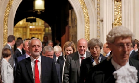 Britain's Prime Minister Theresa May (second right)  and Labour party Leader Jeremy Corbyn (left) walk through the Peer's Lobby during the State Opening of Parliament in the Houses of Parliament in London on June 21, 2017.