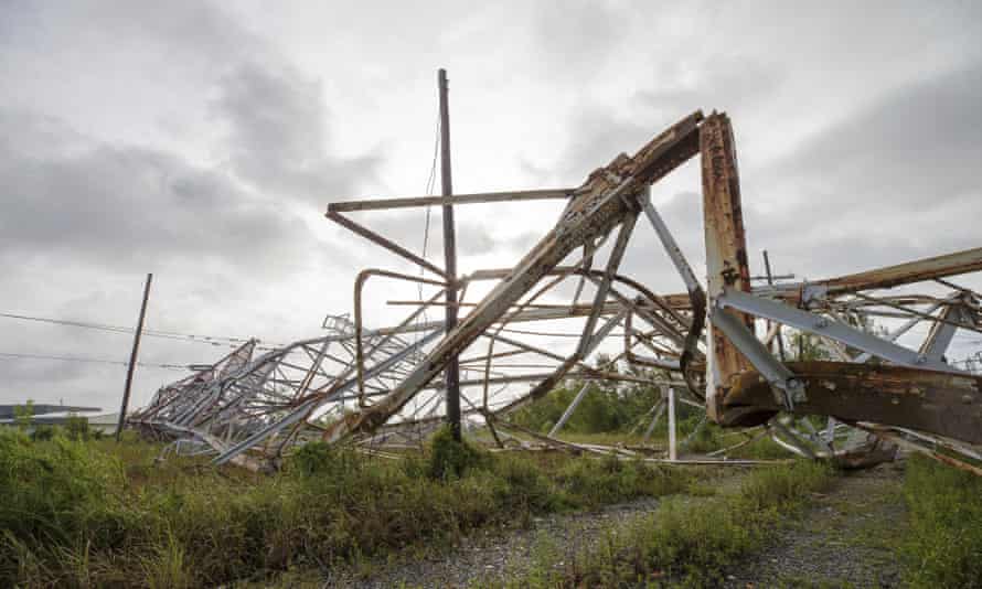 A transmission tower sits on the ground in Bridge City, Louisiana, on Monday.