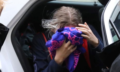 A British woman, accused of lying about being gang raped, covers her face as she arrives at the Famagusta courthouse in Paralimni, Cyprus. 