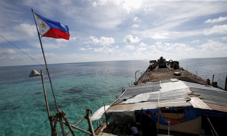 A Philippine flag flutters from BRP Sierra Madre, a dilapidated Philippine Navy ship that has been aground since 1999 and became a Philippine military detachment on the disputed Second Thomas Shoal