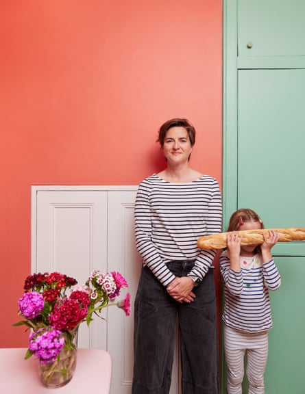 Lotte Jeffs with her daughter. They are both wearing Breton-style tops and her daughter is holding a baguette