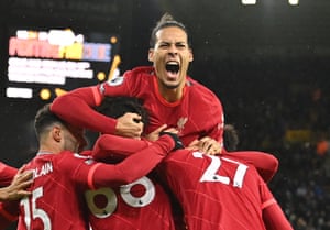 Origi is mobbed by his teammates, including Virgil Van Dijk, as they celebrate his injury time goal.