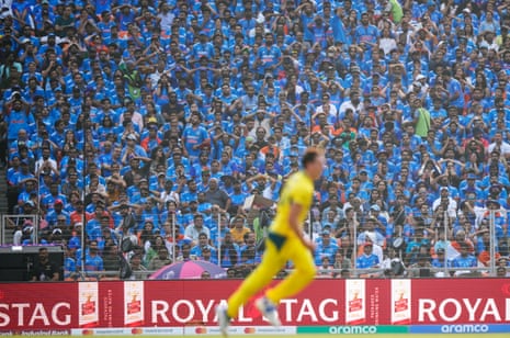 Indian spectators react as Australia's captain Pat Cummins celebrates the wicket of India's Virat Kohli