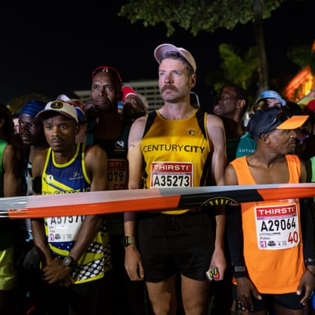 Athletes gather in the dark before the start of the Comrades Marathon in Durban