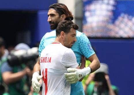 Iran's Alireza Beiranvand and Shoja Khalilzadeh celebrate after the match.