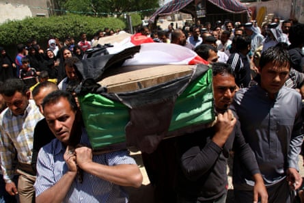Residents carry a coffin during the funeral of an Iraqi soldier in Baghdad on 25 April 2013.