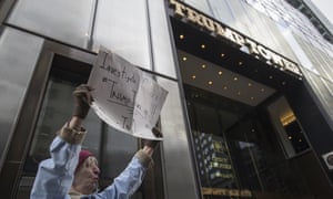 A Donald Trump supporter holds a sign calling for an investigation of Trump’s claim that Trump Tower was wiretapped.
