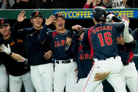Shohei Ohtani celebrates with his teammates after his second-inning grand slam on Friday at the Tokyo Dome.