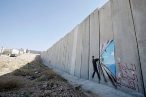 Banksy’s artwork is seen on the West Bank barrier in Abu Dis