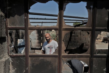 Nasser Shreiteh stands in the scorched remains of his kitchen.
