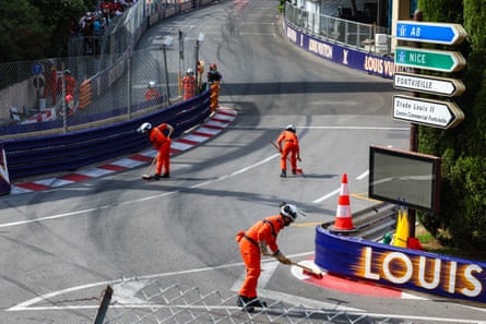 Marshals clear the track under the red flag at Monaco