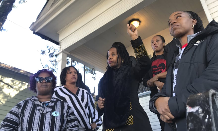 Sharena Thomas, left, Carroll Fife, center, Dominique Walker, second from right, and Tolani King, right, stand outside the home on 10 December.