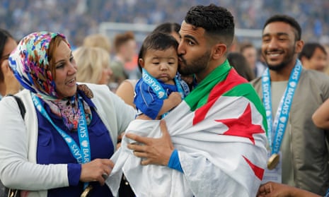 Leicester City’s Algerian midfielder Riyad Mahrez kisses his daughter Inaya as the players celebrate the League title.