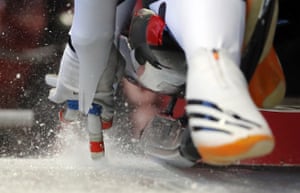 Justin Krewson and Andrew Sherk of the United States start a run during doubles luge training.