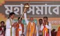 Narendra Modi holds up a mace during an election campaign rally in Agartala, India