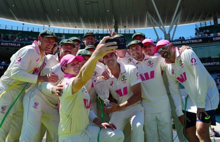 Australia’s Steve Smith takes a selfie teammates as they celebrate with the trophy after winning the Ashes series