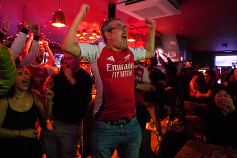 Britain Premier League Arsenal SoccerArsenal supporters celebrate as they watch the