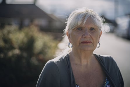 A head and shoulders image of a sad-looking grey-haired elderly woman wearing a grey cardigan