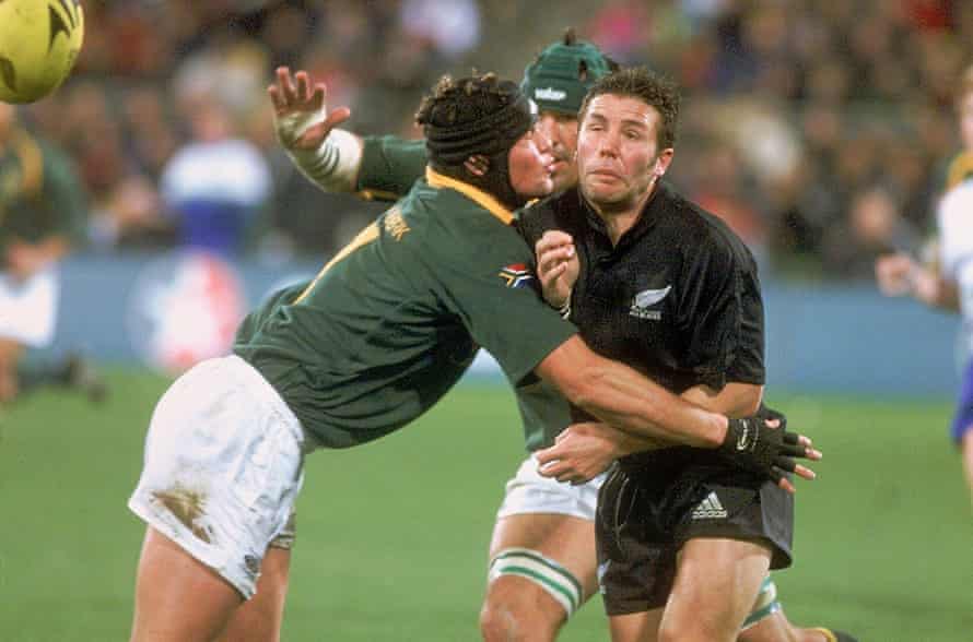 Joe van Niekerk tackles Aaron Mauger of the All Blacks during his debut for the Springboks in 2002.