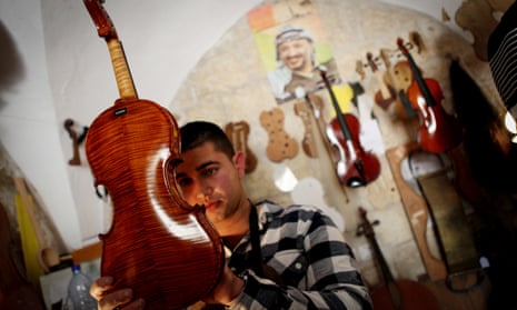 Shehada Shalalda admires a violin in Ramallah.