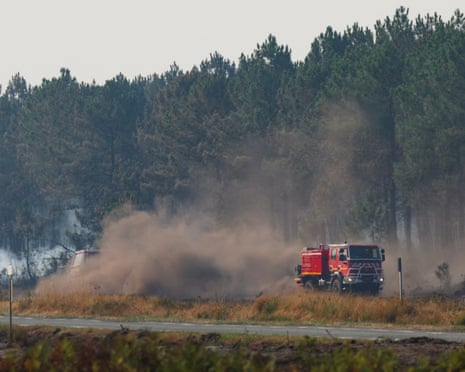 A firefighting vehicle works to extinguish a fire inside a military base during a wildfire, amid drought conditions following a heatwave and water shortages across much of France, in Souge, Gironde, France.