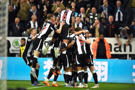 Newcastle United’s English striker Callum Wilson is mobbed by team-mates after his part in Arsenal’s own goal which opened the scoring.
