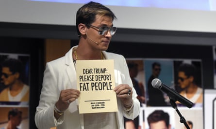 Milo Yiannopoulos holds a sign as he speaks at the University of Colorado campus in Boulder