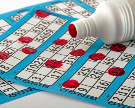 A blue and white bingo card and red dabber