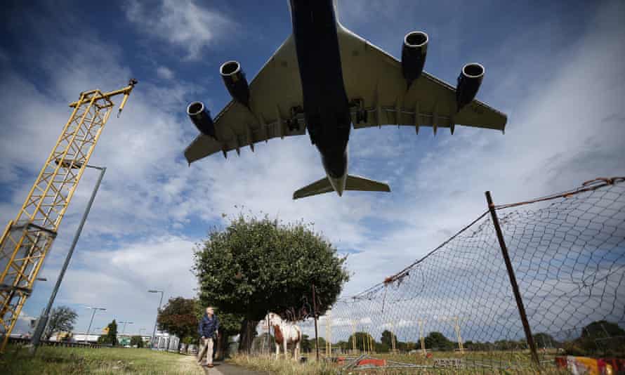 A passenger plane comes over Heathrow airport