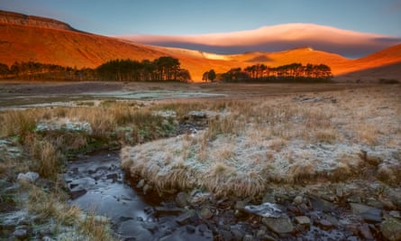 Sunrise hits Pen y Fan in the Brecon Beacons.