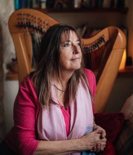 Nickie Aven who sings with the Threshold Choir near Totnes, Devon, photographed at home with her harp