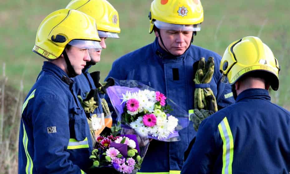 Firefighters arrive with floral tributes for their colleagues at Atherstone on Stour, Warwickshire