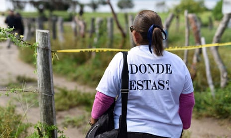 A woman from Solecito Collective, a support group for parents of missing children, wears a shirt that reads “Where are you?” as she stands near the site of a mass grave in Veracruz, Mexico.